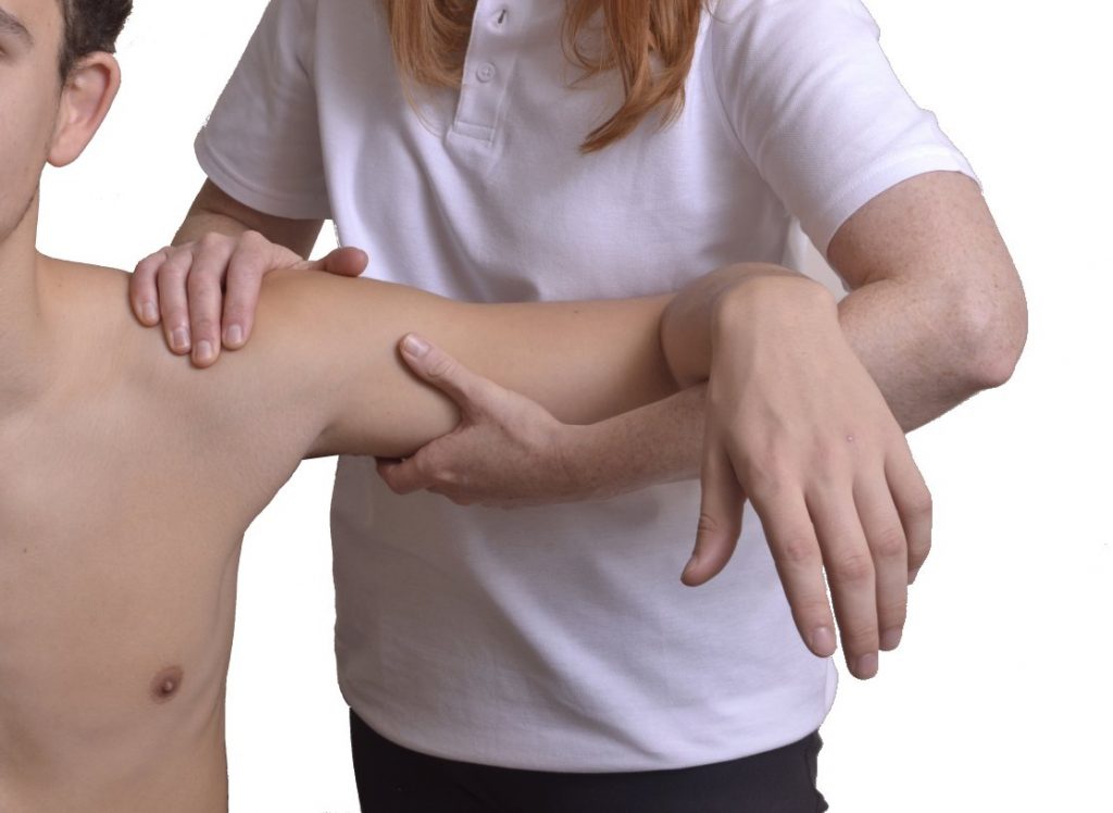 Person adjusting client shoulder